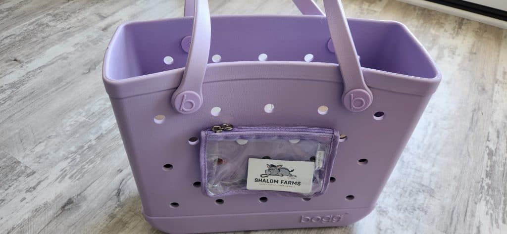 Light purple Baby Bogg Bag with a Shalom Farms business card tucked into the clear front pocket