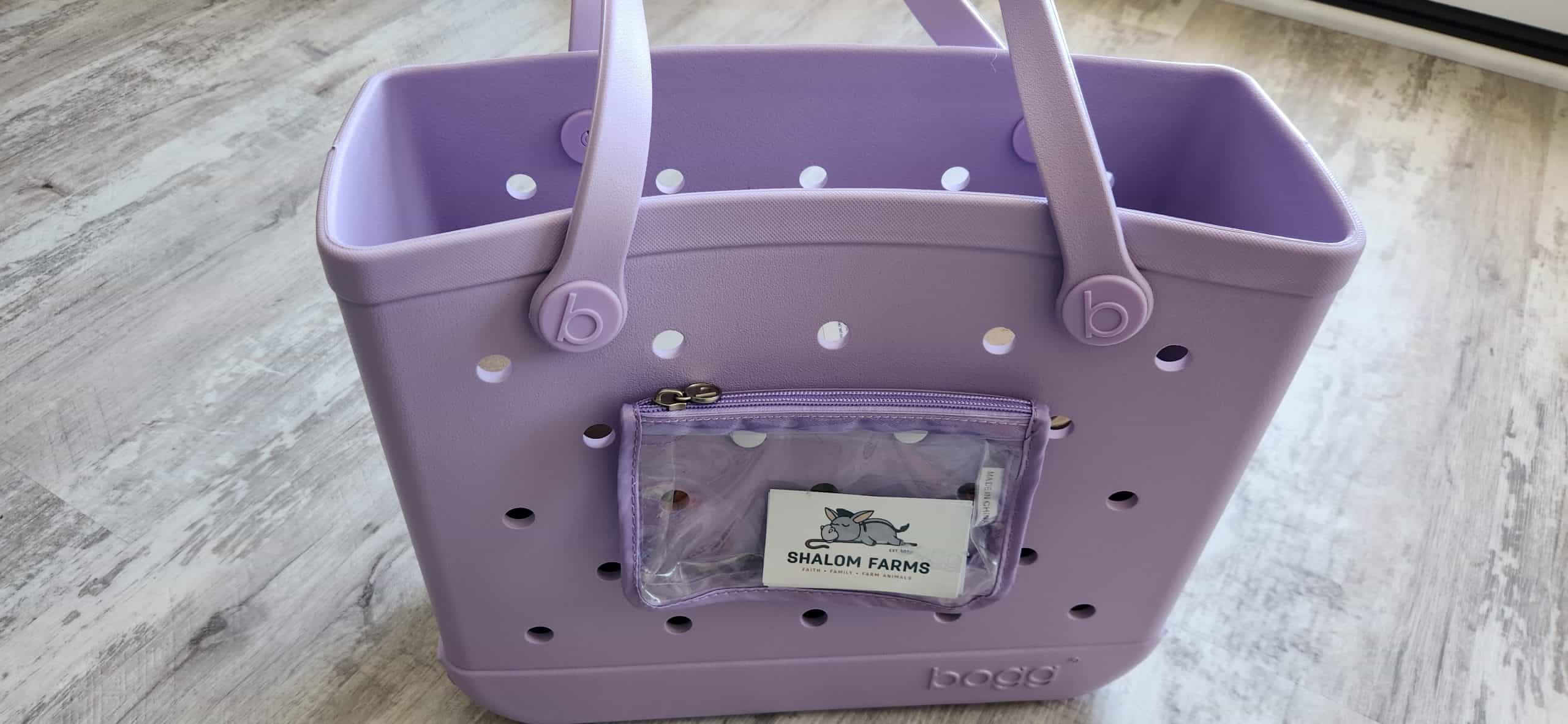 Light purple Baby Bogg Bag with a Shalom Farms business card tucked into the clear front pocket