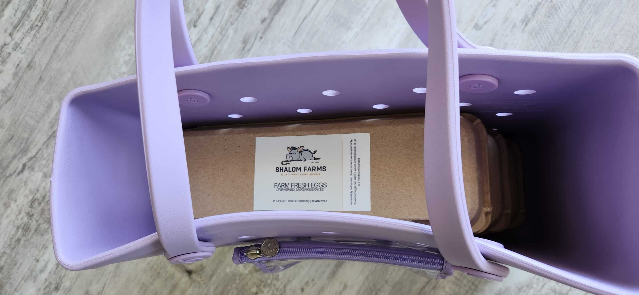 Light purple Baby Bogg Bag packed with Shalom Farms egg cartons
