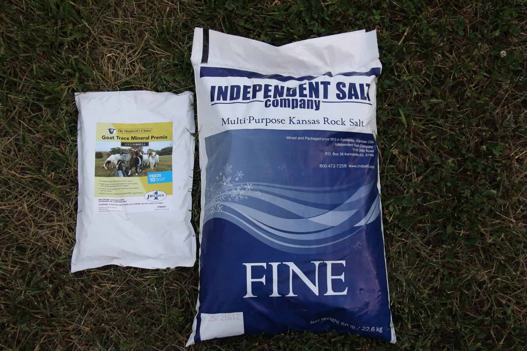 Premier1 Goat Trace Mineral Premix alongside a 50 lb bag of Independent Salt Company fine salt for a DIY loose mineral mix.